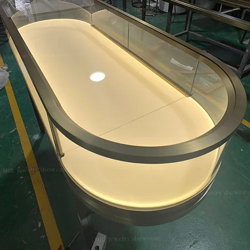 椭圆形珠宝销售柜定制 拉丝香槟金玻璃展示柜 轻奢首饰店专用柜台